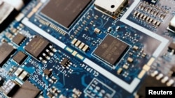 FILE - Semiconductor chips are seen on a circuit board of a computer in this illustration picture taken Feb. 25, 2022.