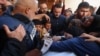 Istri Hamza al-Dahdouh (kanan), jurnalis jaringan televisi Al Jazeera, dan ayah Hamza, Wael al-Dahdouh kepala biro Al Jazeera di Gaza (kiri) berduka saat pemakaman Hamza, yang terbunuh dalam serangan udara Israel di Rafah, Jalur Gaza Senin, 7 Januari 2024.