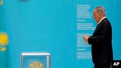 FILE - Nursultan Nazarbayev, Kazakhstan's president, walks to casts his ballot at a polling station in Astana in the country's last presidential election, April 26, 2015.
