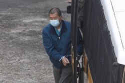 Jimmy Lai of Next Digital, which publishes the Apple Daily newspaper, is escorted by Correctional Services officers to prison, in Hong Kong, Dec. 3, 2020.