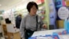 Protection class FFP2 respirator masks are seen inside a pharmacy as a tourist looks at them, amid the novel coronavirus outbreak, in Barcelona, Spain, Feb. 4, 2020.