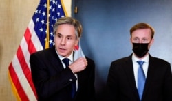 FILE - Secretary of State Antony Blinken, accompanied by national security adviser Jake Sullivan, talks to the media after a closed-door morning session of U.S.-China talks in Anchorage, Alaska, March 19, 2021.
