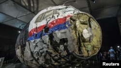 FILE - The reconstructed wreckage of the MH17 airplane is seen after the presentation of the final report into the crash of July 2014 of Malaysia Airlines flight MH17 over Ukraine, in Gilze Rijen, the Netherlands, Oct. 13, 2015. 