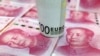 A 100-Euro banknote and Chinese 100-yuan banknotes are seen in this picture illustration, in Beijing, China, Jan. 21, 2016.