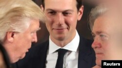 FILE - President Donald Trump talks to Steve Bannon, right, and Jared Kushner during a swearing-in ceremony for senior staff at the White House, Jan. 22, 2017. 