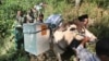 Electoral workers, escorted by police officers and soldiers, use horses to transport ballot boxes to polling stations in remote areas in Tlogosari, East Java, Indonesia, July 8, 2014. 