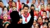 在北京展览馆前面，人们前往参观《砥砺奋进的五年》大型成就展里有中国主席习近平带着少先队的红领巾和少年儿童的合影（2017年10月23日）