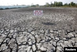 A sign which reads "Land for sale or for lease" is seen placed on a drought-affected rice field in Bac Lieu province, in the Mekong Delta, Vietnam March 30, 2016. Picture taken on March 30, 2016.