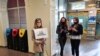 A supporter of Belarusian opposition blogger and activist Raman Pratasevich holding a placard reading 'I am/we are Raman Pratasevich waits for the arrival of a Ryanair flight after it was diverted to Belarus, at Vilnius Airport in Vilnius, May 23, 2021.
