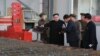 Arhiva - Severnokorejski lider Kim Džong Un, u centru, tokom posete fabrici "16. mart" na fotografiji koju je objavila državna novinska agencija Severne Koreje KCNA, 4. novembra 2019.