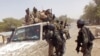 FILE - Cameroon soldiers check a truck on the border between Cameroon and Nigeria, Feb. 19, 2015. Attacks in a Cameroon village along the border from June 25 to 27, 2022, left at least 30 people dead.