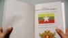 In this photo released by China's Xinhua News Agency, a citizen holds a copy of the Myanmar constitution draft in Yangon, Myanmar, Thursday, April 10, 2008. Myanmar has been launching an official campaign, distributing eight kinds of promotion leaflets to