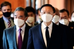 FILE - Yang Jiechi, right, director of the Central Foreign Affairs Commission Office for China, and Chinese Foreign Minister Wang Yi arrive for a meeting with U.S. counterparts in Anchorage, Alaska, March 18, 2021.