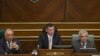 FILE - Parliament Speaker Kadri Veseli, center, addresses Kosovo lawmakers during a debate, Aug. 3, 2015, on constitutional amendments that would allow the establishment of a special court to prosecute its top leaders and former guerrilla fighters for war war crimes in capital Pristina on Monday, Aug. 3, 2015.