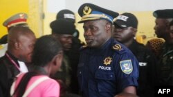 FILE - Former Kinshasa police chief, John Numbi, (C) walks into court,Jan. 27, 2011. Numbi was one of eight police officers accused of the death of a human rights activist in January 2010. 