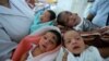 Indian nurses care for newborn babies at the maternity ward of a hospital in Guwahati on the eve of World Population Day, July 10, 2014.