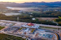In this photo released by Xinhua News Agency, an aerial view shows Ganlanba railway station, one of the stations along the China-Laos railway, under construction Sept. 28, 2021, in China's southwestern Yunnan province.