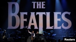 FILE - Paul McCartney and Ringo Starr perform during the taping of "The Night That Changed America: A GRAMMY Salute To The Beatles" in Los Angeles on Jan. 27, 2014. The Beatles are releasing their final single, "Now and Then," in November 2023.
