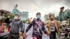 FILE - Protesters march through the streets during an anti-government demonstration in Mandalay, Myanmar, Dec. 7, 2021.