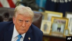 U.S. President Donald Trump speaks to reporters as he signs executive orders in the Oval Office of the White House on Jan. 31, 2025, in Washington.