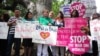 FILE - Supporters of Women's Rights and LGBT groups protest near the Beverly Hills Hotel, owned by the Sultan of Brunei, demanding an end toTaliban-like Brunei penal code which included stoning gay men and lesbians to death and public flogging, May 5, 2014.