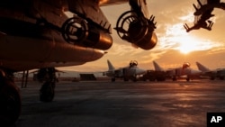 FILE - In this Russian Defense Ministry Press Service photo, a Russian Su-25 ground attack jet is parked at Hemeimeem air base in Syria, with Su-24 bombers seen in the background, Dec. 18, 2015. The bombing Thursday is likely to test already strained relations between the U.S. and Russia.