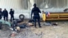 FILE - Federal police stand near the bodies of men who authorities say were suspected cartel gunmen at the Rancho del Sol, near Ecuanduero, in western Mexico.