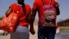 FILE - Asylum-seeking migrants from Haiti walk before crossing the Rio Bravo river to turn themselves in to U.S Border Patrol agents to request asylum in El Paso, Texas, as seen from Ciudad Juarez, Mexico April 22, 2022. 