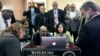FILE - Muslim, Christian, minority and government leaders fix their eyes on a laptop screen showing a video as part of the Countering Violent Extremism program at Roxbury Community College in Boston, March 31, 2015. 