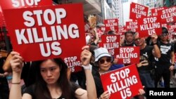 Protesters hold placards as they attend a demonstration demanding Hong Kong's leaders to step down and withdraw the extradition bill, in Hong Kong, June 16, 2019. 