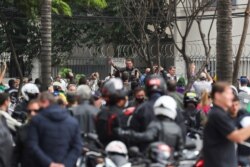 Brazil's President Jair Bolsonaro waves as he arrives to participate in a motorcade rally amid the coronavirus disease (COVID-19) pandemic, in Sao Paulo, Brazil, June 12, 2021.