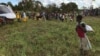 A boy watches the distribution of aid materials in the remote village of Bopira, Mozambique, April 6, 2019. 