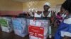 A voter casts her ballot during Liberia's presidential and legislative election in Monrovia on Oct. 10, 2023.