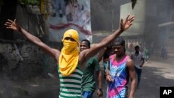 FILE - People protest the assassination of Haitian President Jovenel Moïse in Haiti, July 8, 2021. Canadian federal police said Nov. 17, 2022, that they have charged a man in Quebec province for allegedly plotting to sow violence in Haiti and overthrow its government. 