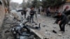 FILE - Afghan journalists film at the site of a bombing attack in Kabul, Afghanistan, Feb. 20, 2021. 