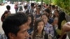 FILE - Myanmar citizens wait for their turn outside the Myanmar Embassy in Singapore to cast advance ballots in the country's Nov. 8 general election, Oct. 18, 2015. 
