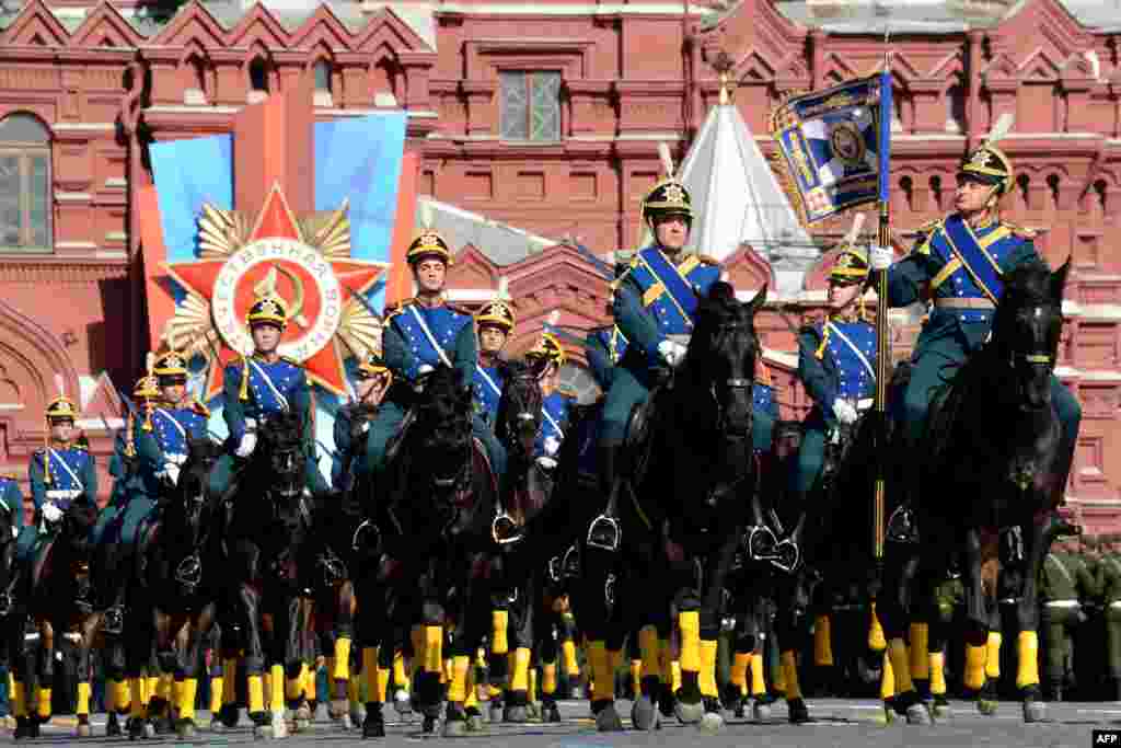 Russian honour guard troopers ride during a Victory Day parade at the Red Square in Moscow, May 9, 2014. 