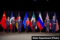 FILE - Secretary Kerry stands with fellow EU, P5+1 foreign ministers and Iranian Foreign Minister Zarif after reaching Iran nuclear deal, in Vienna, Austria, July 14, 2015.