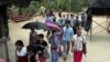 FILE - Karen refugees leave after a church service at Mae La refugee camp in Ta Song Yang district of Tak province, northern Thailand, April 12, 2013. With the end of military rule in Myanmar, aid groups are still working on returning the refugees to Myanmar.