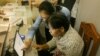 Voter registration official talks to an eligible voter to verify detail information for her to register for the local elections next year, in Phnom Penh, on Thursday, September 1, 2016. (Hean Socheata/VOA Khmer)
