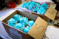 FILE - Boxes of N95 protective masks for use by medical field personnel are seen at a New York state emergency operations incident command center during the coronavirus outbreak in New Rochelle, N.Y., March 17, 2020.