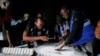 Ghana counts votes in tight presidential race, hopes for better times