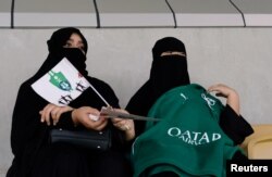 Saudi women watch the soccer match between Al-Ahli against Al-Batin at the King Abdullah Sports City in Jeddah, Saudi Arabia, Jan. 12, 2018.