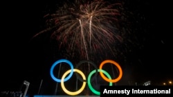 FILE - Fireworks explode behind the Olympic rings during their inauguration at the Madureira Park in Rio de Janeiro, Brazil, May 20, 2015. 