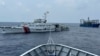 FILE - A Chinese coast guard ship, left, and a Chinese militia vessel, right, blocks a coast guard ship from the Philippines as it heads toward Second Thomas Shoal in the South China Sea, Oct. 4, 2023. The ASEAN hopes to reduce risk of conflict in the area with a code of conduct.