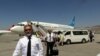 Sekelompok pilot dari maskapai Ariana Afghan tampak berjalan di area Bandara Internasional Hamid Karzai di Kabul, Afghanistan, setelah mendarat pada 5 September 2021. (Foto: AP)