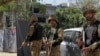 Pakistani soldiers stand alert at the site of an explosion, in Lahore, Pakistan, Thursday, Feb. 23, 2017. A Pakistani provincial minister says an explosion has killed at least eight people in the eastern city of Lahore. 
