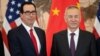 China's Vice Premier Liu He stands next to U.S. Treasury Secretary Steven Mnuchin as they pose for a group photo at Diaoyutai State Guesthouse in Beijing, March 29, 2019.