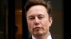 FILE - Tesla CEO Elon Musk and his security detail depart the company’s local office in Washington, Jan. 27, 2023.