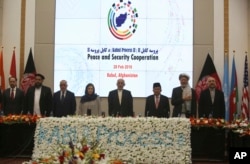 Afghan President Ashraf Ghani, center, and delegates stand for the national anthem during the second Kabul Process conference at the Presidential Palace in Kabul, Afghanistan, Feb. 28, 2018.